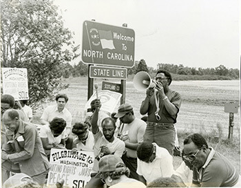 Elaine Tomlin, Joseph Lowery leading a prayer during the 1982 Pilgrimage to Washington for Voting Rights, Peace, Economic Justice, North Carolina, 1982. Courtesy of SCLC records, MARBL, Emory University. Elaine Tomlin, Joseph Lowery leading a prayer during the 1982 Pilgrimage to Washington for Voting Rights, Peace, Economic Justice, North Carolina, 1982. Courtesy of SCLC records, MARBL, Emory University.