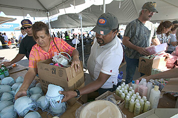 Andrea Booher, Evacuee Umberto Romero gathers food and necessities at the distribution center at the Chalmette Recovery Center set up following Hurricane Katrina, New Orleans, Louisiana, October 22, 2005. South Carolina Cares set up similar centers in Columbia, South Carolina.