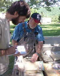 Zachariah McCannon, Searcy County miller Rick Horton discussing local corn varieties with University of Georgia anthropology graduate student James Veteto, Searcy County, 2009.