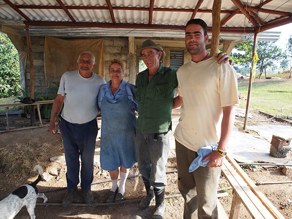 Maria and Augostín (in hat) with their only son Royber and Maria's brother, a neighboring farmer, pictured on the patio at their farm. Pinar del Rio, Cuba, January 2011. Maria and Augostín (in hat) with their only son Royber and Maria's brother, a neighboring farmer, pictured on the patio at their farm. Pinar del Rio, Cuba, January 2011.