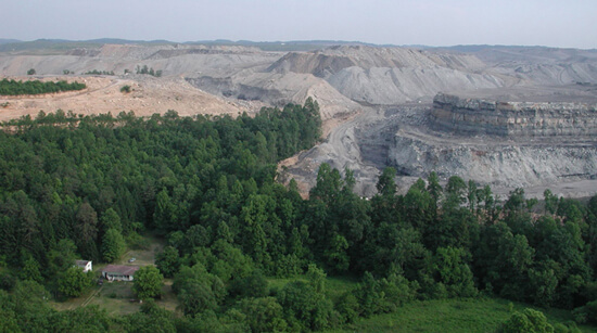 Vivian Stockman, A home on Mud River is dwarfed by the massive mountaintop removal mine that surrounds it, Lincoln/Boone County line, West Virginia, 2005. Vivian Stockman, A home on Mud River is dwarfed by the massive mountaintop removal mine that surrounds it, Lincoln/Boone County line, West Virginia, 2005.
