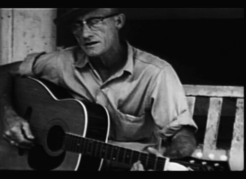 Roscoe Halcomb playing guitar on his front porch in The High Lonesome Sound Roscoe Halcomb playing guitar on his front porch in The High Lonesome Sound
