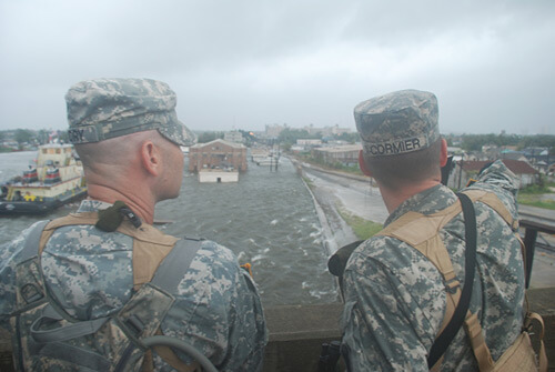 Chuck Simmins, Louisiana National Guardmen observe as water from the industrial canal overtops the levees, New Orleans, Louisiana, September 2008.