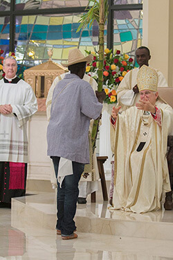 Archbishop Thomas Wenski receiving offertory gifts of fruits and native plants from parishioners, Notre Dame d'Haiti Catholic Church dedication service, Miami, Florida, February 1, 2015. Photo by Ana Rodriguez-Soto. Courtesy of the Archdiocese of Miami. Archbishop Thomas Wenski receiving offertory gifts of fruits and native plants from parishioners, Notre Dame d'Haiti Catholic Church dedication service, Miami, Florida, February 1, 2015. Photo by Ana Rodriguez-Soto. Courtesy of the Archdiocese of Miami.