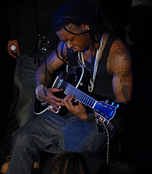 Lil Wayne plays the guitar, Washington, DC, January 15, 2008. Photograph by Flickr user Georgetown Voice. Courtsey of Georgetown Voice, Creative Commons License CC-BY-NC-SA 2.0. Lil Wayne plays the guitar, Washington, DC, January 15, 2008. Photograph by Flickr user Georgetown Voice. Courtsey of Georgetown Voice, Creative Commons License CC-BY-NC-SA 2.0.