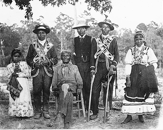 Group of Choctaw men, a young woman and a young girl posed outdoors, probably at a stick ball game, Neshoba County and Scott County, Mississippi, 1908. Photograph by Mark Raymond Harrington. Courtesy of the National Museum of the American Indian, Mississippi Choctaw Collection, N02667. Group of Choctaw men, a young woman and a young girl posed outdoors, probably at a stick ball game, Neshoba County and Scott County, Mississippi, 1908. Photograph by Mark Raymond Harrington. Courtesy of the National Museum of the American Indian, Mississippi Choctaw Collection, N02667.