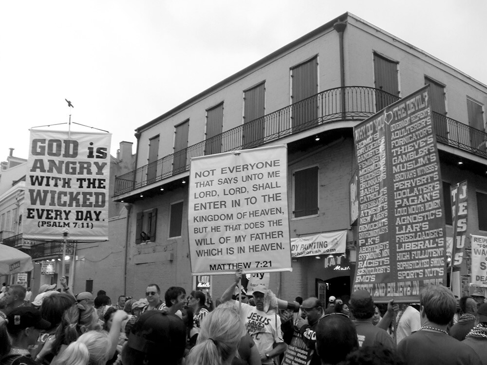 Pick Your Poison, Bible-bangers on Bourbon Street during Mardi Gras, New Orleans, February 5, 2008. Photograph by Flickr user MA1216. Creative Commons license CC BY-NC-ND 2.0. Pick Your Poison, Bible-bangers on Bourbon Street during Mardi Gras, New Orleans, February 5, 2008. Photograph by Flickr user MA1216. Creative Commons license CC BY-NC-ND 2.0.