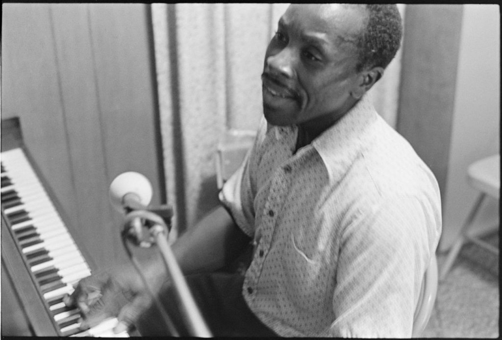 Theotis Taylor Fitzgerald sings at his piano.