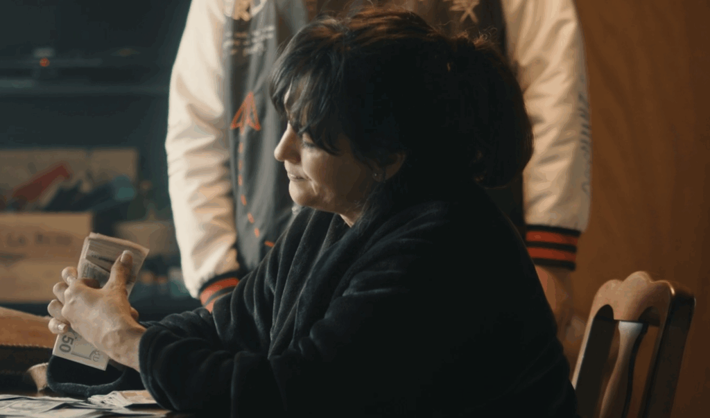 Connie counting money from drug sales.