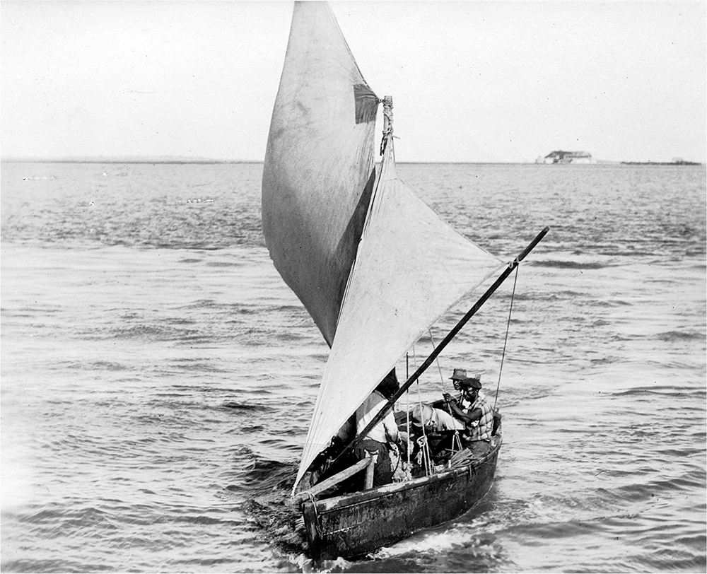 Small sailboat with several Black seated.