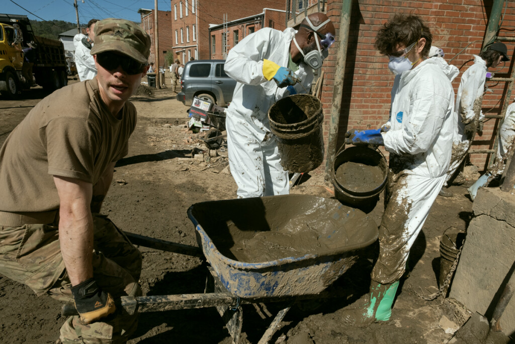 Members of the 101st Airborne Division from Ft. Campbell, Kentucky, mucking the basement of the Madison County Arts Council building on Main Street in downtown Marshall, North Carolina, after Hurricane Helene.