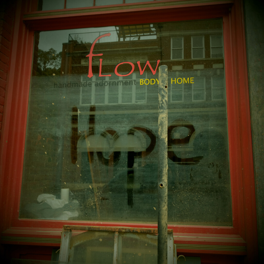 Front window of Flow gallery on Main Street, Marshall, North Carolina, with message “Hope” on window after Hurricane Helene.

