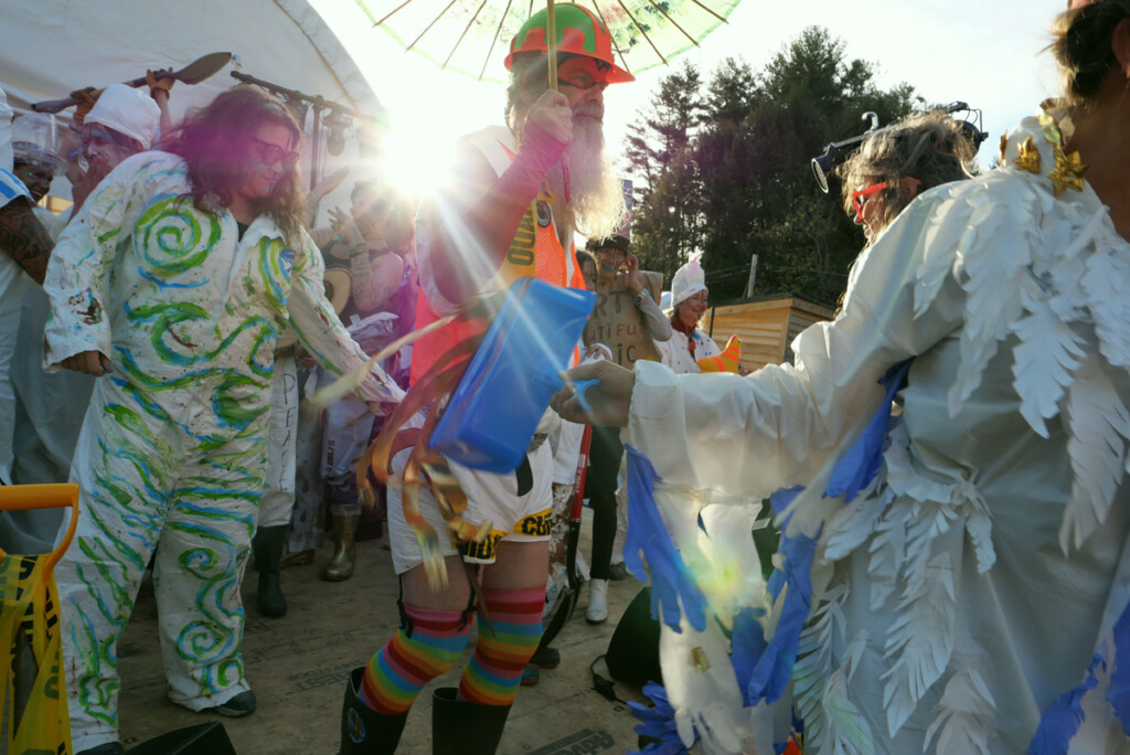Dancing at a Tyvek Fashion show at the Nanostead staging area, Marshall, North Carolina, after Hurricane Helene.
